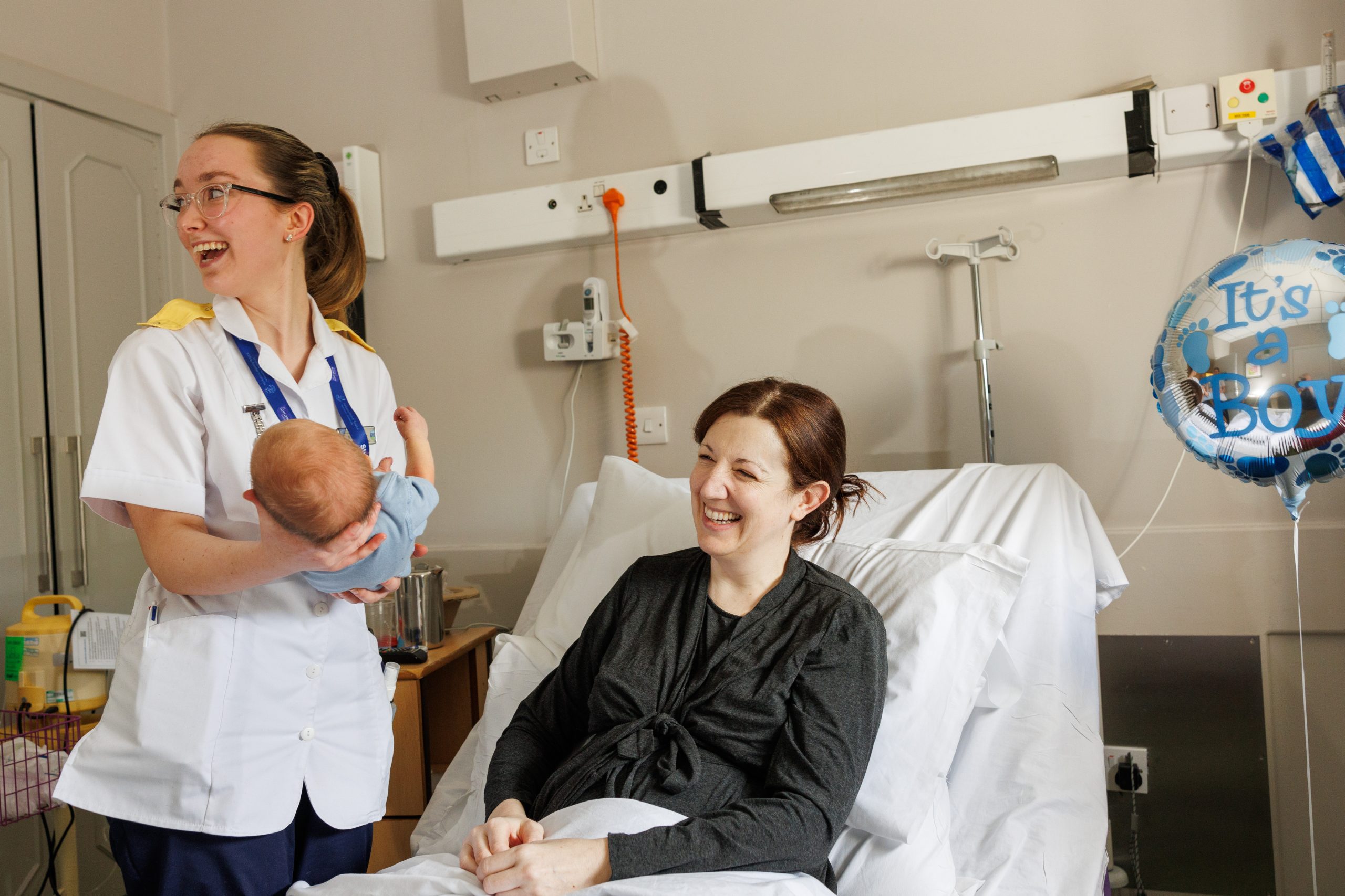 Midwife with mum and new baby