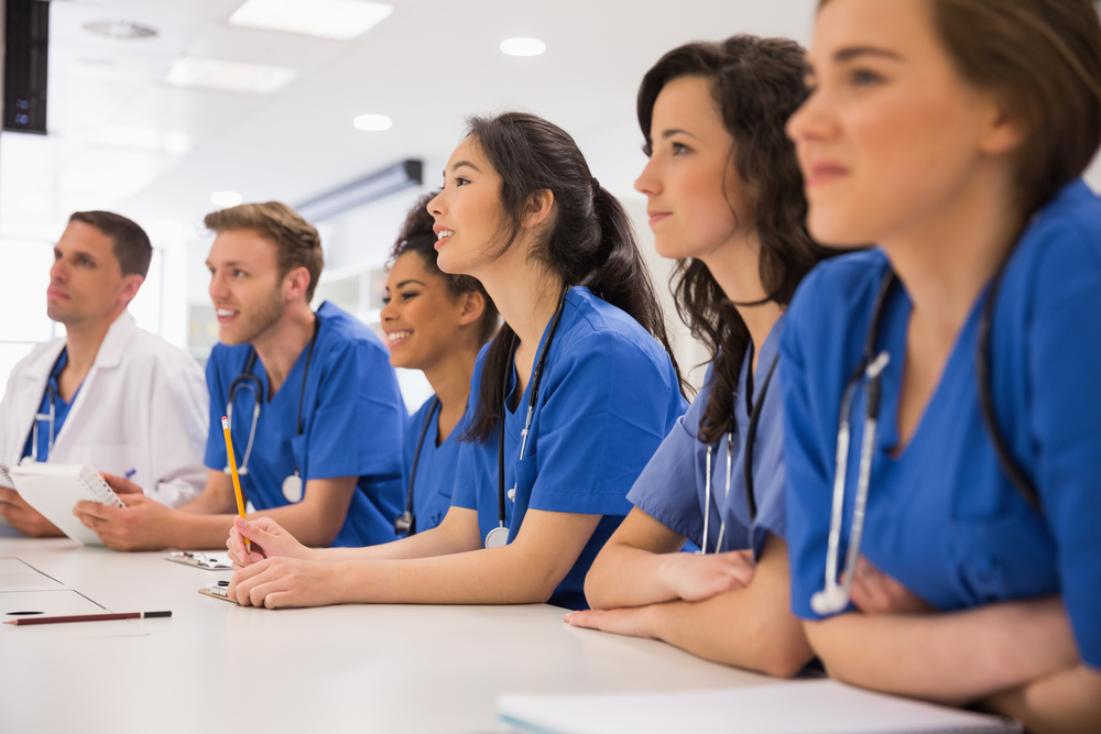 Group of medical students at a desk in university