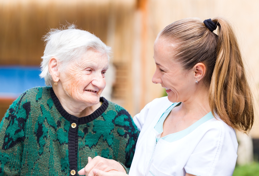 elderly woman with her caregiver