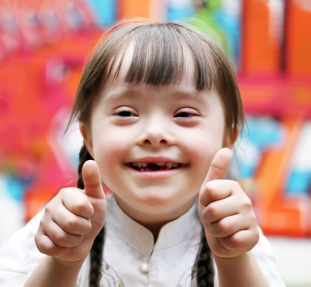 young girls giving a thumbs up