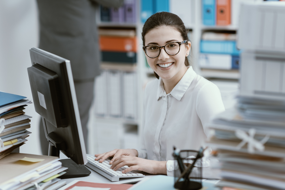 Young Admin person Working At Office Desk on a computer