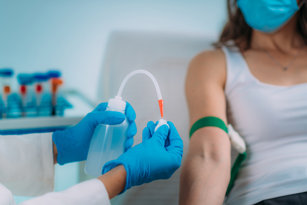 Preparation for phlebotomy procedure, female patient