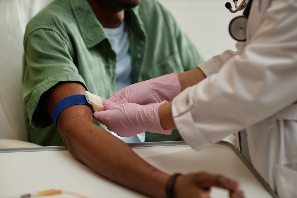 Phlebotomist preparing patient