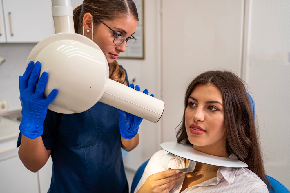 Dental nurse taking a dental X-ray
